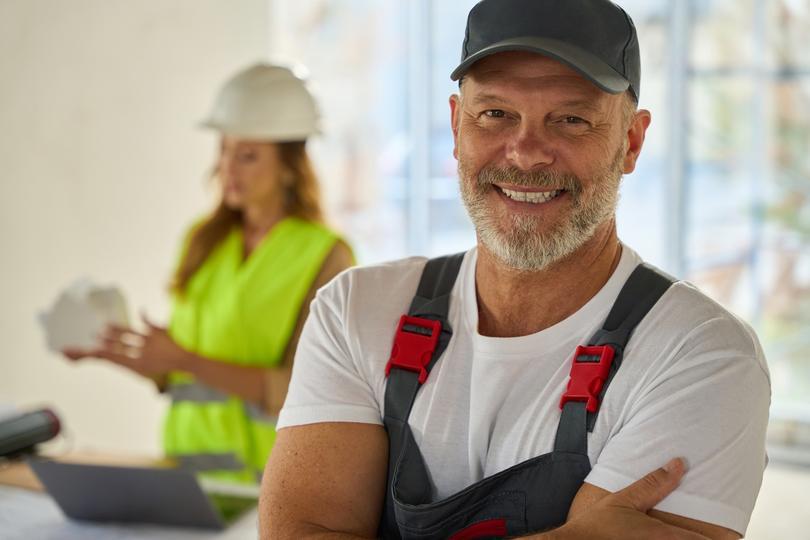 sms-marketing-agency for home service companies  - portrait-of-smiling-home-contractor